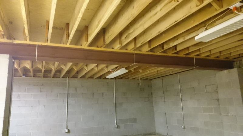 An actual W8x58 steel beam supporting the floor joists in the basement.